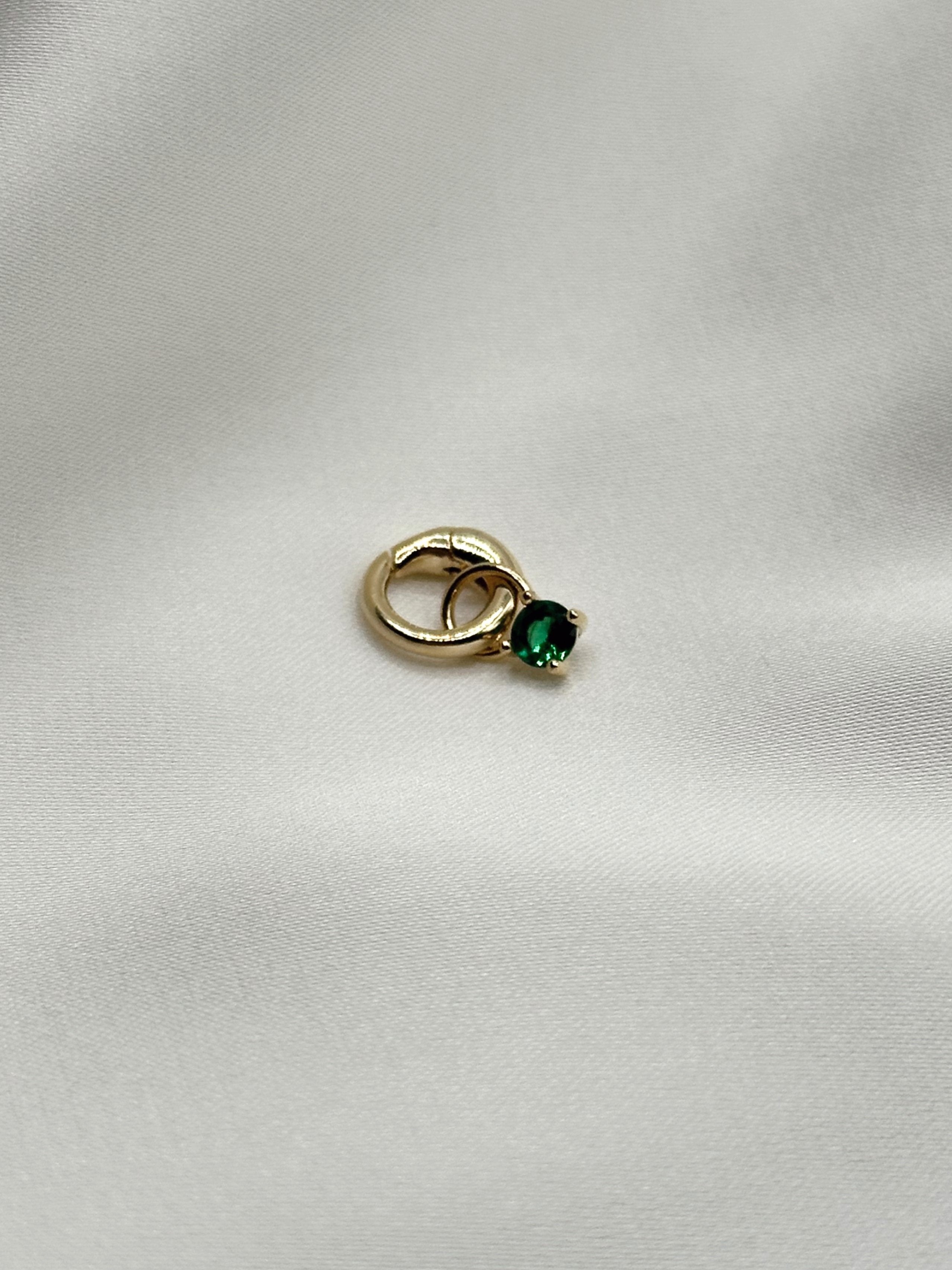 Emerald rhinestone gold charm against a white background.