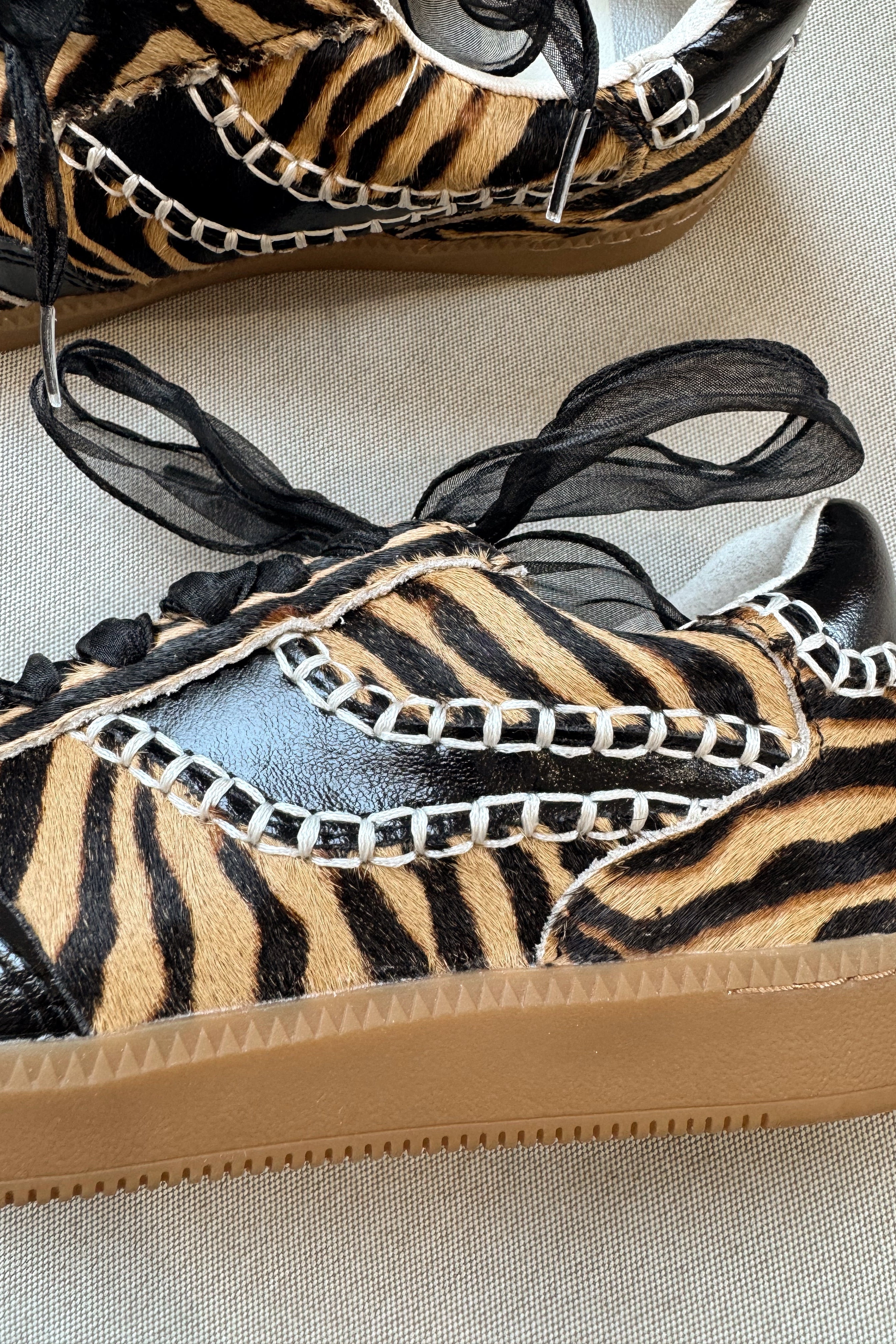 Dolce Vita Notice Stitch Tiger Calf Hair Sneaker- close up side view
