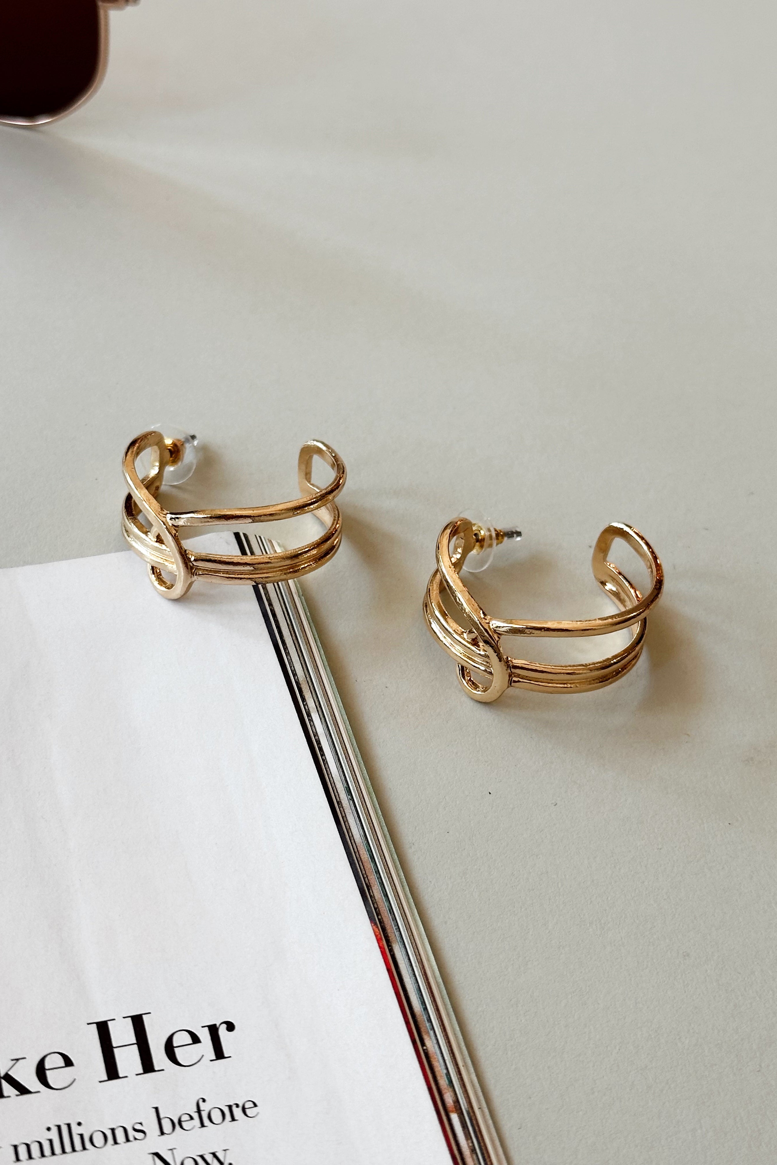 Justine Gold Twist Hoop Earrings - flat lay close up