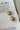 Margaret Gold Starburst Scoop Huggie Earrings - flat lay top view