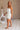 Romy White Strapless Ruffle Mini Dress - full body side view