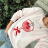Eve Light Pink Cherry Martini Sweater - angled front view