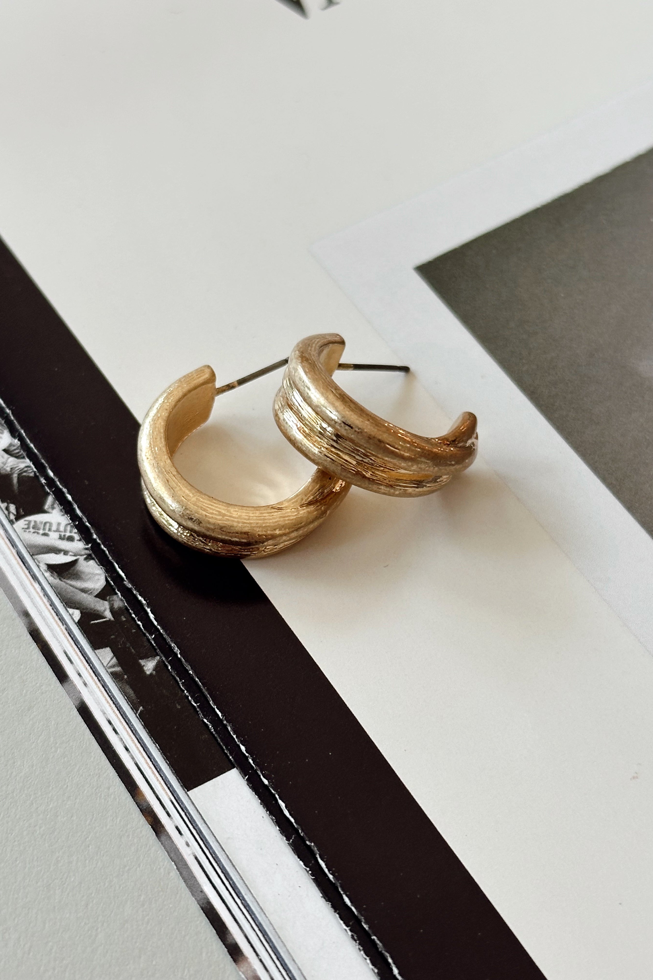 Tana Brushed Gold Hoop Earrings- flat lay close up
