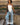 model wearing white top and jeans