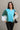 Front view of model wearing the Ashley Blue Multi Color Block Sweatshirt which features blue, green and white knit fabric, a color block pattern, textured details, a collared neckline with a v-cutout, and long sleeves with elastic cuffs.