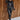 Full body front view of model wearing the Lyra Black Sequin Long Sleeve Top that has black sequin fabric, black lining, a cropped waist, a round neckline, a back zipper, and long sleeves.