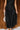 Lower front view of model wearing the Colette Black Floral Satin Midi Dress that has black satin fabric, monochrome florals, a assymetrical ruffle tier design, pleated fabric, a cowl neck, and thin straps.