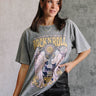 Front view of model wearing the Rock 'N' Roll Washed Short Sleeve Graphic Tee that has washed cotton fabric, a round neck and short sleeves. Graphic says "Rock N' Roll, World Tour" with a guitar and angel wings.