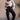 Full body view of model wearing the Ayla Washed Black Cargo Adjustable Jogger Pants which features washed black ribbed fabric, two front pockets, elastic waistband with drawstring tie, two side cargo pockets with tortoise button and wide pant legs with dr