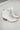 Side view of the Untie Ankle Boot that features a white PU material, a traditional western boot silhouette, a shortened shaft, western inspired embroidery, a zipper closure, and a stacked 2" heel.