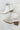 Aerial view of the Untie Ankle Boot that features a white PU material, a traditional western boot silhouette, a shortened shaft, western inspired embroidery, a zipper closure, and a stacked 2" heel.