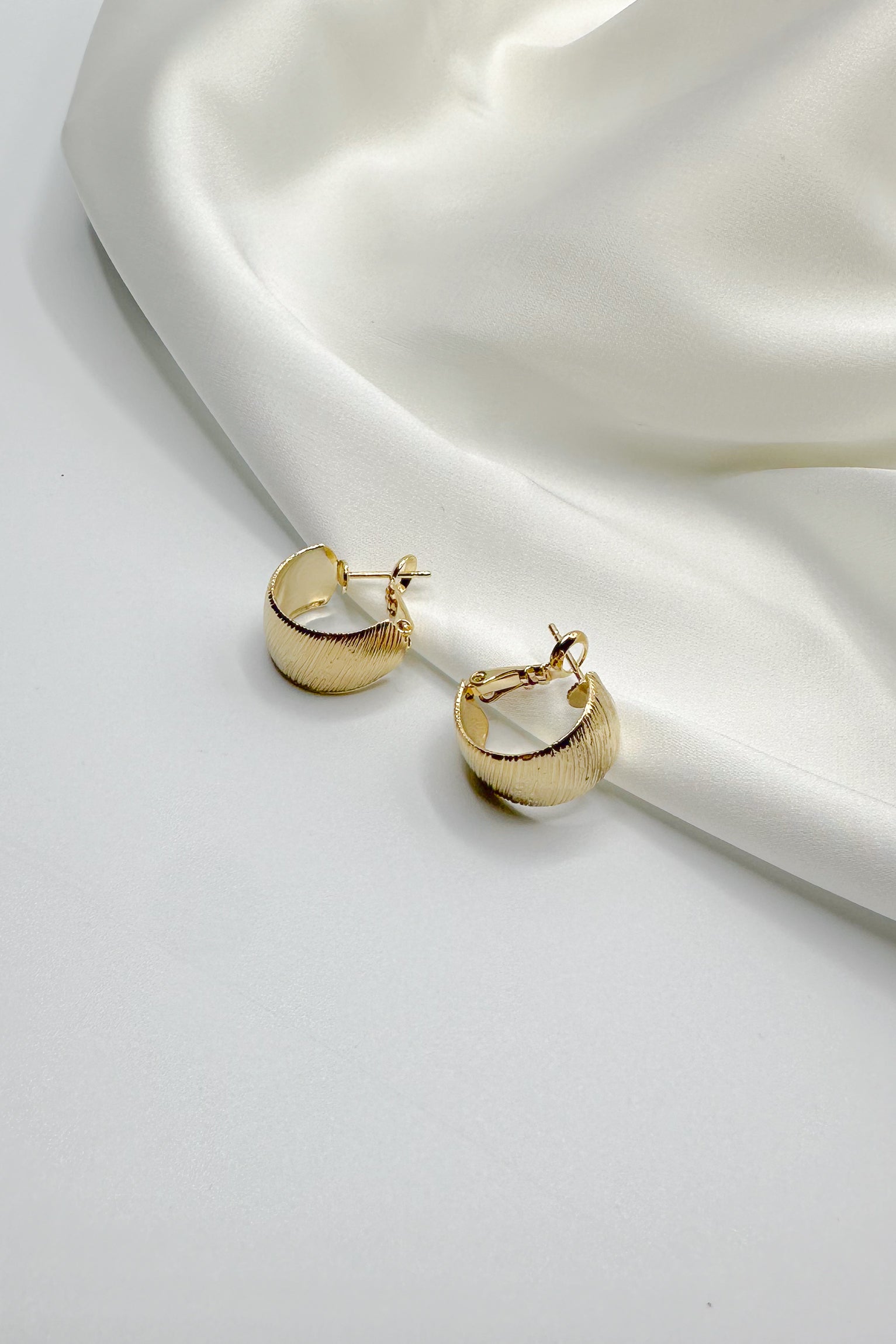 Andrea Brushed Gold Huggies Earring- close up view