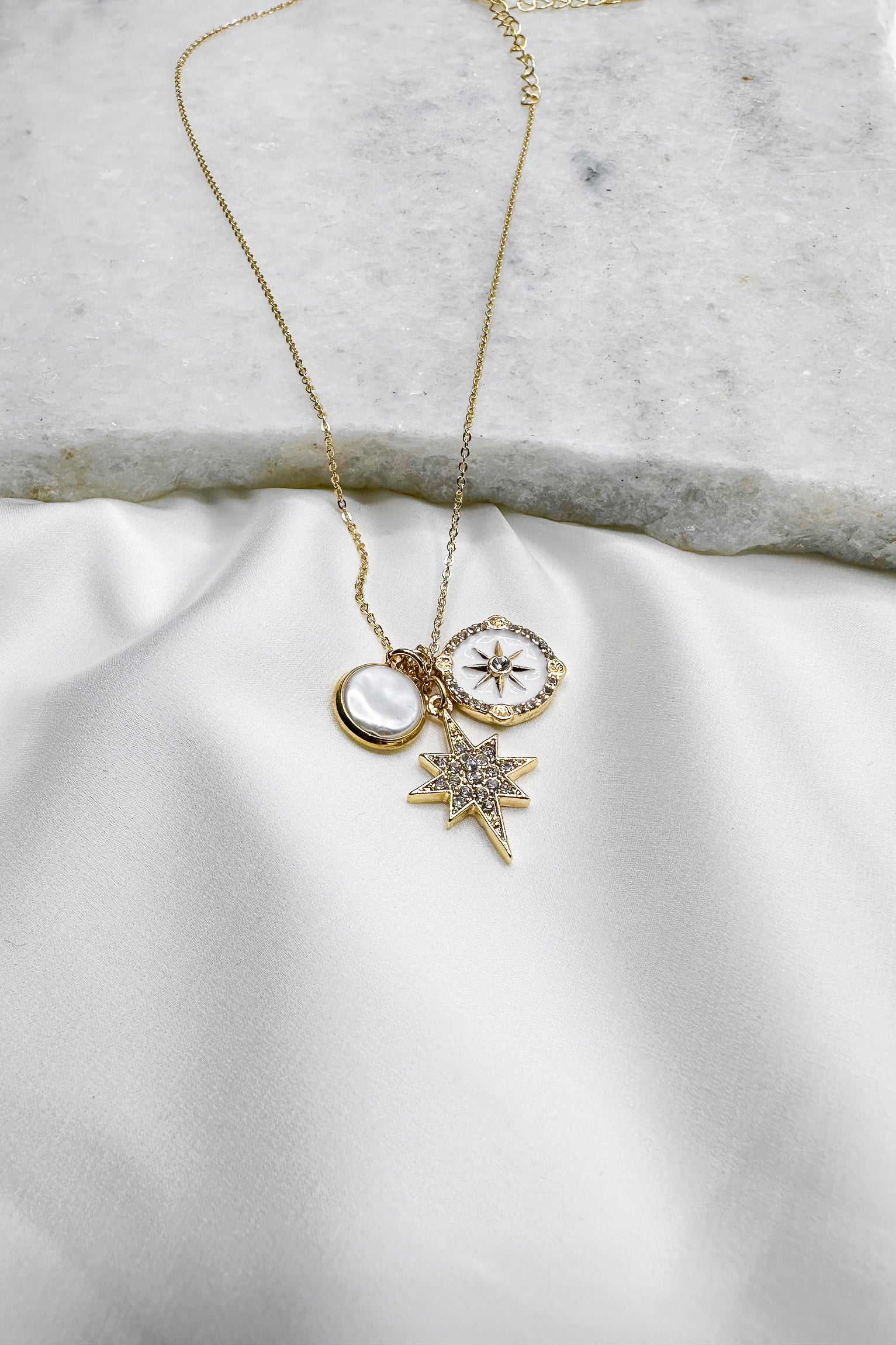 Luna Gold & Pearl Starburst Medallion Necklace- close up view