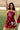 Full body front view of female model wearing the Anya Burgundy Faux-Leather Strapless Dress that has burgundy faux-leather fabric, a strapless neck, and mini-length hem.