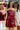 Full body front view of female model wearing the Anya Burgundy Faux-Leather Strapless Dress that has burgundy faux-leather fabric, a strapless neck, and mini-length hem.