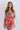 Front view of model wearing the You're A Jewel Floral Dress, which features a multi-colored floral print, a smocked bodice with a sweetheart neckline, long balloon sleeves with elastic wrists, and a tiered skirt