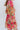 Close-up side view of model wearing the You're A Jewel Floral Dress, which features a multi-colored floral print, a smocked bodice with a sweetheart neckline, long balloon sleeves with elastic wrists, and a tiered skirt