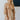 Front view of model wearing the Wonderful Life Dress in Champagne, which features  iridescent fabric, 3/4 balloon sleeves with buttoned cuffs, a v neck and back, and a cutout at the waist