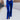 Front view of model wearing the On The Horizon Velvet Pants, which feature cobalt blue velvet, front ankle slits, and a high-rise elastic waist.