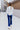 Full body back view of model wearing the On The Horizon Velvet Pants, which feature cobalt blue velvet, front ankle slits, and a high-rise elastic waist.