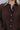 Close-up front view of model wearing the Upstate Open-Back Top in Brown, which has textured brown fabric, a button-up front with a collar neckline, long sleeves, and a twist in the back with an open slit.
