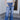 Front view of model wearing the Rooted Denim: Slit Flare Jeans, that feature medium-wash denim with light distressing, flared legs with slits on the outer ankle, and front and back pockets.