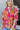 Front view of model wearing the Feeling Fine Top, which features a brown, pink, and orange swirl print, a high neckline, half-length sleeves, and a flowy fit..