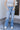 Front view of model wearing the Ceros: Charlotte Dad Jeans, which feature medium-wash-denim with light distressing, a straight let fit, and front and back pockets