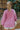 Back view of model wearing the More Self Love Sweatshirt, which has a purple colored material, a round neckline with a ribbed trim, a long sleeve, a purple and orange graphic front reading "More Self Love", and side slits