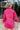 Back view of the Stolen Dreams Top that features a hot pink material, a collar neck and button-up front, pleated 3/4 sleeves with a bow at the wrist, and a curved bottom hem with side slits.