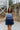 Frontal view of the Light of Your Life Mini Dress that features a tulle material, a monochromatic tiered design, a straight neckline, a sleeveless design with thin adjustable straps, a back zipper closure, and a mini length.