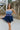 Frontal view of the Light of Your Life Mini Dress that features a tulle material, a monochromatic tiered design, a straight neckline, a sleeveless design with thin adjustable straps, a back zipper closure, and a mini length.