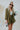 Frontal view of the Livin' The Dream Blazer that features an olive green colored material, a collar and lapel, an open front, a 3/4 cuffed sleeve, and two front pockets.