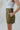 Side view of the Livin' The Dream Shorts that features an olive green colored material, a high-rise fit, an elastic waist, a belt detail, side pockets, and a flowy fit.