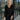 Frontal view of the Slipped Away that features a black colored knit material, a surplice neckline, a long sleeve, ruched side detailing with adjustable strings, a side slit, a mini length, and a tight fit.