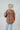 Back view of the Can't Stop Me Flannel Jacket that features a rust colored flannel material, a multi-colored plaid pattern, a brown thermal material hood with adjustable strings, a button-up front, long cuffed sleeves, a brown thermal material siding, a f