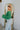 Side  view of the She's So Lucky Cropped Cardigan, that features a green knit material, a V neckline, a two button-up front, long sleeves, and a cropped fit