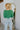 Back view of the She's So Lucky Cropped Cardigan, that features a green knit material, a V neckline, a two button-up front, long sleeves, and a cropped fit