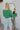 Back view of the She's So Lucky Cropped Cardigan, that features a green knit material, a V neckline, a two button-up front, long sleeves, and a cropped fit