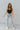 Frontal view of the Signature 8: Next Move Straight Leg Jeans that features a medium wash denim, a high-rise fit, a button and zipper closure, two front pockets, distressing at the knee, a raw distressed hem, two back pockets, and a straight leg fit.