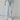 Frontal view of the Signature 8: Next Move Straight Leg Jeans that features a medium wash denim, a high-rise fit, a button and zipper closure, two front pockets, distressing at the knee, a raw distressed hem, two back pockets, and a straight leg fit.