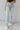 Frontal view of the Signature 8: Next Move Straight Leg Jeans that features a medium wash denim, a high-rise fit, a button and zipper closure, two front pockets, distressing at the knee, a raw distressed hem, two back pockets, and a straight leg fit.