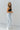 Side view of the Signature 8: Next Move Straight Leg Jeans that features a medium wash denim, a high-rise fit, a button and zipper closure, two front pockets, distressing at the knee, a raw distressed hem, two back pockets, and a straight leg fit.