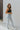 Side view of the Signature 8: Next Move Straight Leg Jeans that features a medium wash denim, a high-rise fit, a button and zipper closure, two front pockets, distressing at the knee, a raw distressed hem, two back pockets, and a straight leg fit.