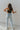 Back view of the Signature 8: Next Move Straight Leg Jeans that features a medium wash denim, a high-rise fit, a button and zipper closure, two front pockets, distressing at the knee, a raw distressed hem, two back pockets, and a straight leg fit.