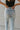 Back view of the Signature 8: Next Move Straight Leg Jeans that features a medium wash denim, a high-rise fit, a button and zipper closure, two front pockets, distressing at the knee, a raw distressed hem, two back pockets, and a straight leg fit.
