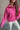 Close front view of model wearing the Hot Pink Quarter-Zip Sweatshirt that has hot pink knit fabric with a soft fleece interior, long raglan sleeves, a quarter-zip front with a high neck, and a kangaroo pocket.