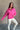 Front view of model wearing the Hot Pink Quarter-Zip Sweatshirt that has hot pink knit fabric with a soft fleece interior, long raglan sleeves, a quarter-zip front with a high neck, and a kangaroo pocket.