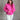 Front view of model wearing the Hot Pink Quarter-Zip Sweatshirt that has hot pink knit fabric with a soft fleece interior, long raglan sleeves, a quarter-zip front with a high neck, and a kangaroo pocket.
