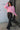 Full body front view of model wearing the Catherine Pink Heathered Mock Neck Sweater that has pink and white heather knit fabric, ribbed hem, a high neck, and long balloon sleeves with cuffs.